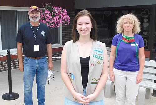 Joey Manning, a member of Stewartville Girl Scout Troop 44038, foreground, is one of five troop members and graduating seniors with the Stewartville High School class of 2020 who donated unsold Girl Scout cookies to Family Service Rochester's Meals on Wheels program. Standing socially distant behind Joey are Tonja Ziemann, senior independence program assistant for Family Service Rochester, which organizes the Meals on Wheels program, at right; and Ron Randall, an Americorps member who volunteers for Family Service Rochester.