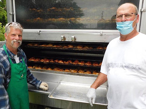 Scott Hurley of Parties Made Simple of Grand Meadow, left, cooked 512 chicken halves for the Racine Lions Club's 36th annual Chicken BBQ and Dance at Racine City Hall on July 18. The Racine Lions Club uses proceeds from the event to support the club's local projects. Doug Irlbeck, president of the Racine Lions Club, is at right.