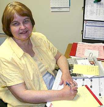 Shirley Hinze works at her desk. 
