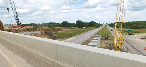 Mathiowetz Construction, a contractor for the Minnesota Department of Transportation (MnDOT), is continuing its two-year project to replace two Hwy. 63 bridges at the intersection of Interstate 90 and Hwy. 63 just north of Stewartville. Mathiowetz workers will build new bridges, widened to accommodate three lanes and shoulders, and an extended acceleration lane for drivers heading northbound on Hwy. 63. The photo above, taken from one of the Hwy. 63 bridges, shows the work continuing at far left, just north of the eastbound and westbound lanes of I-90.
