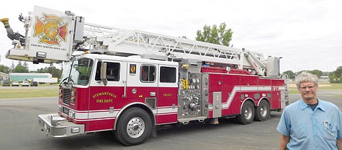 Captain Steve Denny, at right above, stands near the Stewartville Fire Department's 2004 Seagrave model ladder truck, which is 43 feet, two inches long and weighs 76,000 pounds loaded.