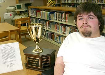 HE'S A WINNER -- Rusty Hagan, a senior at Stewartville High School,  has been named the winner of the Matt Smith Memorial Trophy, named in honor of Matt Smith, who played for the Rochester Raiders adaptive floor hockey team from 1991 to 1997. The trophy honors an adaptive athlete who loves to compete and unselfishly supports his teammates. To the left of the trophy is a written statement that describes why the trophy was named in Smith's honor. 