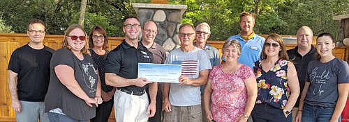 In the midst of challenging economic times caused by the COVID-19 pandemic, the Stewartville Area Community Foundation has donated $5,000 to the Stewartville Area Chamber of Commerce to encourage local businesses to support Summerfest. Al Chihak, chair of the Foundation, fourth from right in front, presents the check to the Chamber's Jared Johnson of Anytime Fitness. Others include, front row, from left, Gwen Ravenhorst, Chamber administrator; Myrna Welter, Chamber membership coordinator; Alisha Nelson, First American Insurance Services; and Regan Lonien, Foundation member. Back row, from left, Dan Honsey, Patty Geerdes, Robert Hruska and Jeff Beyer, all Foundation members; Ed Kruger of EZ Camper Rental; and Scott Nelson of the Foundation.