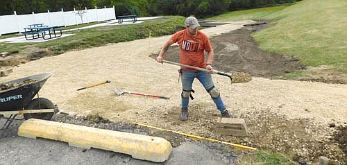Ryan Mosch, owner of Stewartville's Dairy Queen, worked hard on Tuesday, Sept. 1 to add a retaining wall to the trail that will lead from Dairy Queen to a nearby city bicycle and walking path. Stewartville residents are looking forward to the trail's completion. "They're already using it,"&#8200;Mosch said.