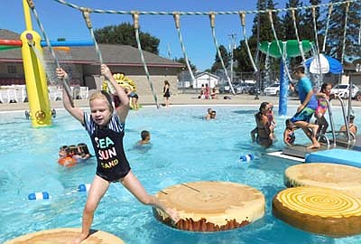 The Stewartville pool closed for the season on Labor Day, Monday, Sept. 7. Five days before, Gwen Herman, 6, of Rochester, hangs on to the ropes as she attempts to cross the pool on a set of imitation logs on Wednesday afternoon, Sept. 2.
