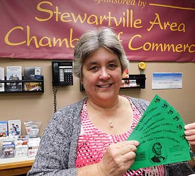 Myrna Welter, membership coordinator for the Stewartville Area Chamber of Commerce, displays a sampling of Chamber Bucks that will be taken out of circulation as of Dec. 31, 2020.