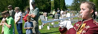 Sara Zent plays taps at Woodlawn Cemetery during the Memorial Day ceremony. 
