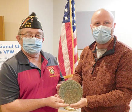 Jim Parry, REACH coordinator at Stewartville High School-Middle School, right, shares a grave marker inscribed with the name of World War I veteran Charles Lenton with Roger Peterson, commander of the Stewartville American Legion Post 164. Parry found the marker while using his metal detector at Bear Cave Park. In 		the inset photo above left, Charles 