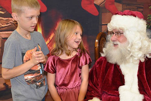 Pictures with Santa, sponsored by the Stewartville Kiwanis Club, a longtime Stewartville Christmas tradition, was cancelled this year by the coronavirus (COVID-19) pandemic. Last year, Rachel Reiland, then 6, of Stewartville, shared her Christmas list with Santa Claus as her brother Jonathan, then 8, waited his turn.