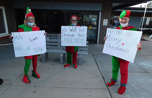 Employees of the Stewartville Care Center's activities department, dressed as elves, shared uplifting Christmas messages with the Care Center's residents last week. From left are Sue Warmka, activities director, and Tammy Wuerflin and Alan Miller, activities assistants. Chris Gleason, dressed as Santa Claus, also shared some Christmas cheer, delivering homemade cookies to the Care residents.