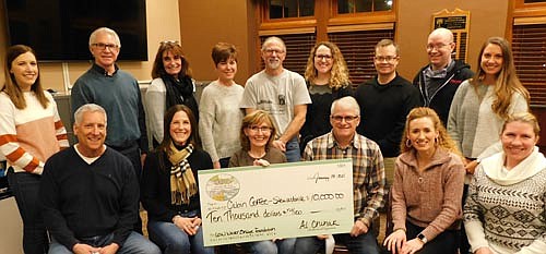 Tom and Sue Slightam, owners of Jimmy's Salad Dressings & Dips, seated at left in the front row, have donated $10,000 to the Stewartville Area Community Foundation, which will distribute the money to the owners of the new Cabin Coffee shop in Stewartville, including, starting from third from left in the front row, Robin and Kevin Splittstoesser, Leigh Dzubay and Hannah Lechner. Community Foundation members include, standing from left, Regan Lonien, Jeff Beyer, Patty Geerdes, Lisa Lonien, Al Chihak, Kayla Beyer, Dan Honsey, Robert Hruska and Emily Fritsch. The money will come from the Slightams' Low Water Bridge Foundation, established in 2017 to assist selected entrepreneurs with the startup phase of their businesses.