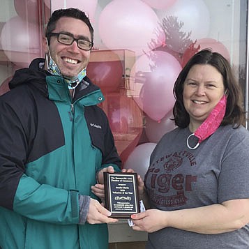 Jen Schurmeier, right, accepts the Stewartville Area Chamber of Commerce's Volunteer of the Year Award from Jared Johnson, Chamber president for 2021. Schurmeier earned the honor for decorating many Stewartville storefronts for Christmas and Valentine's Day