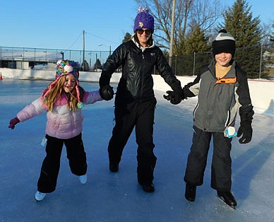 Crystal Landherr, center, brought her children, Mason and Emma, to Meadow Park last week, where the kids enjoyed ice skating for the first time, skimming across the city of Stewartville's new Dasher Board System 4 hockey rink on Tuesday afternoon, Feb. 2. "We just got them their skates for their birthdays, Jan. 25 and 26," Crystal said. "We had birthday week last week."
