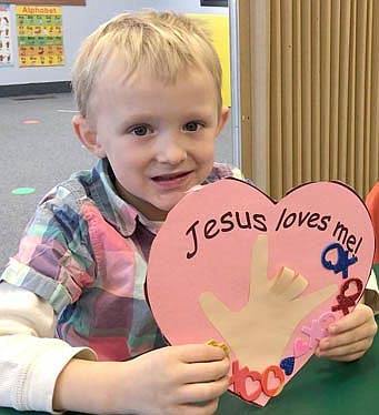 Children at St. John's Wee Care Learning Center celebrated Valentine's Day a few days early last week, working on heart-shaped projects on Wednesday, Feb. 10. Charlie Frank, 4, left, displays his valentine, which includes the sign language symbol for "I Love You."