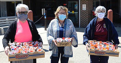 Stewartville Morning Lions Club members Janet Speltz, left, and Sheila Majerus, right, delivered May baskets to residents of the Stewartville Care Center on Friday, May 30. Sue Warmka, activities director at the Care Center, accepts the baskets.