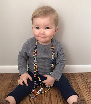 Logan Olson poses with his Beads of Courage.