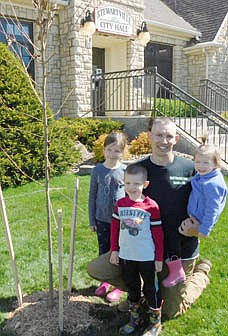 John Cavanaugh, owner of Bluff Country Tree Service LLC, has donated 10 trees to the city of Stewartville. Cavanaugh and his children, from left, Paisley, 7; Preston, 4; and Nettie, 2; planted an oak tree near Stewartville City Hall last week. When it's full grown, the tree should be about 70 feet tall, Cavanaugh said. The oak was planted near the spot where an ash tree had stood for many years. The ash, infected with the emerald ash borer, was removed several weeks ago. The Cavanaughs also planted two other donated trees near City Hall and seven at Bear Cave Park.