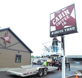 Workers from Nagle Signs, Inc., of Waterloo, Iowa, installed the sign for the new Cabin Coffee Co. in Stewartville last week. Hannah Lechner, one of the owners of the business, said Cabin Coffee is scheduled to open in late June