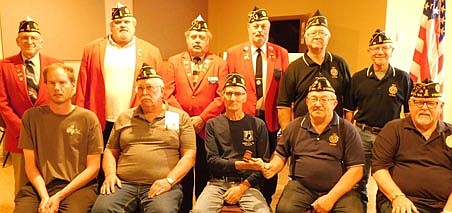 Visiting dignitaries installed new 2021-22 officers for the Stewartville American Legion Ivan Stringer Post 164 on Monday evening, May 17.  The officers include, front row, from left, Allen Santema, chaplain; Wayne Bamlet, finance officer; Ron Moore, incoming commander, accepting the gavel from Roger Peterson, outgoing commander; and Richard Paulson, historian. Visiting officers who presided at the installation include, back row, from left, Dale Wellik, first district commander; Mark Maloney, Area 1 vice commander; Myron Ehrich, first district membership; and Gary Miller, past district commander; along with Wes Alrick, judge advocate, and Roger Barsness, adjutant for the local Legion. Other 2021-22 Legion officers missing from the photo include Troy Helget, first vice commander; Kristin Anderson, second vice commander; George Beach, service officer; and Dean Ramaker, sergeant-at-arms.