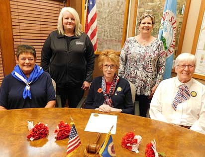To honor America's veterans, members of the Stewartville American Legion Auxiliary Unit 164 will distribute poppies in exchange for donations at Stewartville's two Kwik Trip stores, two Casey's stores and Fareway on Friday, May 28, National Poppy Day; and Saturday, May 29. Proceeds from the distribution will pay for veterans programs. Legion Auxiliary members who will help with the distribution include, seated from left, Peggy Paulson, first vice president; Wanda Prescher, president; and Delores Peterson, member. In back, from left, are Laurel Jacobs, city data clerk, and Cheryl Roeder, city clerk and a member of the Legion Auxiliary, who welcomed the Legion Auxiliary members to City Hall last week. "The memorial poppy, assembled by disabled veterans, pays respectful tribute to those killed in war, and also benefits living veterans and their families," says the city proclamation placed on the desk, front and center. The proclamation declares May 2021 Poppy Month in the city of Stewartville.