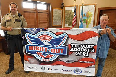 National Night Out, an annual community-building campaign that promotes police-community partnerships and neighborhood camaraderie to make neighborhoods safer, more caring places to live, will be held in Stewartville on Tuesday, Aug. 3. Jason Owen, Stewartville's community oriented policing (COPS) deputy, left, and Mayor Jimmie-John King hold the banner announcing the event.