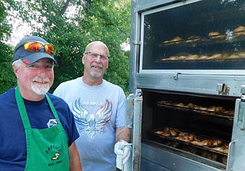 Bill Hurley of Parties Made Simple of Grand Meadow, left, cooked 480 chicken halves for the Racine Lions Club's 37th annual Chicken BBQ and Dance at Racine City Hall on Saturday, July 17. The Racine Lions Club uses proceeds from the event to support the club's local projects. Doug Irlbeck, president of the Racine Lions, is at right. Also, Redemption Road performed at a free street dance that evening from 8 p.m. to midnight, and residents took part in a cash raffle, with proceeds designated for student scholarships.