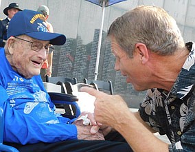 After waiting for more than three quarters of a century, Racine's Joyce Johnson, left, has the medals he earned for flying the B-17 Flying Fortress in World War II. He got them on his 100th birthday at a ceremony honoring him for his military service at the Soldiers Field Veterans Memorial in Rochester on Tuesday, July 20. Kent Larson of Stewartville, right, Johnson's former Racine neighbor, enjoyed a lively conversation with Johnson after the ceremony.