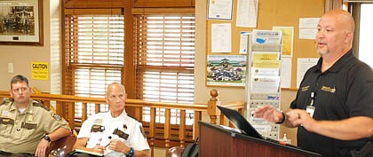 Olmsted County Sheriff's Office Chief Deputy Terry Waletzki, at the podium at right, shares a report with the Stewartville City Council at Stewartville City Hall on Tuesday evening, July 27. Listening at left, from left, are Sheriff's Capt. Chris Wallace and Sheriff Kevin Torgerson.