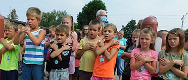 The children from St. John's Lutheran Church's Vacation Bible School, including, front row, from left above, Wyatt Feltis, Harrison Petersen, Dawsyn Hanson, Zeke Kumfer, Hazel Roeder, Aubrie Schaefer and Vayda Russell, sang about their love for Jesus with all their hearts at the Stewartville Care Center on Friday morning, Aug. 6. Care Center residents, at left, from left, Mary Hustak, applauding, and Wes and Ruth Faul, showed their appreciation for the music.