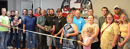 The Stewartville Area Chamber of Commerce held a ribbon-cutting ceremony to welcome 2 Brothers Authentic BBQ as Chamber members on Wednesday evening, Aug. 18. Sam and Seth Stier, owners of the business, front and center in black, cut the ribbon to celebrate the occasion as other Chamber-member business leaders show their support, including, in front, from left, Keenan Kolstad, Exterior Cleaning Solutions; Melissa Sue Leuning and Porter, Premium Support Bookkeeping; Dave Hildebrandt, Hildebrandt Services; Charlie Brown, PC Applications; Sam Steir and Seth Steir, owners; Myrna Welter, Chamber membership coordinator; Samantha Welter and Izzy, Welter Entertainment; and Gwen Ravenhorst, Gwen's Confections and Chamber administrator. Back row from left, Paulette and Bruce Teigen, Premium Support Bookkeeping; Josh Buckmeier, ONB Bank; Jason Post, Carpenters Local Union #1382; Margaret Nelson, State Farm Insurance; Robert Hruska, Fareway; Al Chihak, R & C Storage; Jared Johnson, Chamber president, Halcon; Kevin Welter, Welter Entertainment; and Ryan Ravenhorst and daughter Gretta, Insul Seal.