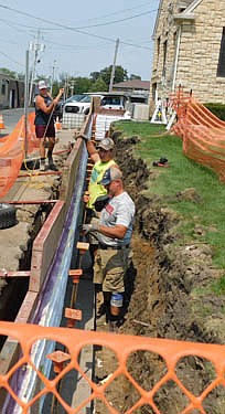 Workers from Byrne Construction of Stewartville began the process of replacing and rebuilding the deteriorating retaining wall just west of City Hall last week. The new wall will measure 86 feet by six feet by eight feet.
