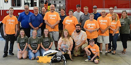 Beginning fourth from left in the front row, Erin and Darwin (DJ) Olson, with their son, Logan, along with members of a committee that organized a community appreciation event this past May (wearing the orange shirts), presented a Lucas device, used for mechanical chest compression, to the Stewartville Fire Department last week. Front row, from left, are Karisa Stevens, Kayla Stevens, Kendra Stevens, Erin Olson, Logan Olson, Darwin Olson and Liam O'Neill. Second row, from left, Cole Hintz, Jim Elliott, Mike Hintz, Molly Hintz, Sharon Bernard, Gene Bernard, Lacie Tingesdal and Gwen Stevens. In back, from left, Greg House, Steve Wolf, Lisa Jelinek, Dan Swanson, Aaron Jones, Benjamin Wolf and Chris Tingesdal.