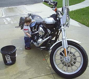 22 month old Zachary Hanson "helps" wipe the water off dad's motorcycle.   