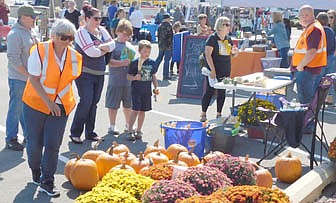 The Stewartville Morning Lions Club sold plenty of pumpkins and mums at the Club's annual Fall Festival on Saturday, Sept. 18. Morning Lions members Sheila Majerus, left, and Brian Bushman, wearing the orange vests, welcomed many visitors to the Club's sales area.