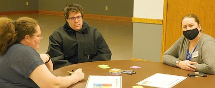 Brea Grace of Short Elliott Hendrickson (SEH), the city of Stewartville's engineering firm, an SEH senior planner and project manager for updating the city of Stewartville's comprehensive plan, right, joins Stewartville residents Beth and Mitchell Jay at a workshop to discuss the plan at the Civic Center last week. The Jays posted a number of suggestions for Stewartville's future, including the importance of maintaining Stewartville's small-town feel and character, and making an effort to preserve some of the city's older, historical buildings.