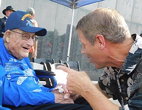 On July 20, after finally receiving the medals he earned for flying the B-17 Flying Fortress in World War II, Joyce Johnson, 100, left, speaks with former Racine neighbor Kent Larson.