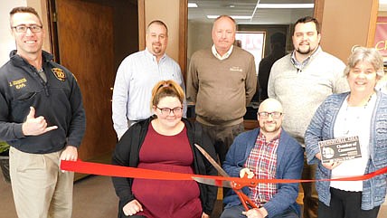 The Stewartville Area Chamber of Commerce welcomed Weekend Nirvana as a new Chamber member at an ambassador visit at the Chamber office along Main Street on Wednesday, Jan. 5. Mark and Karli Young, owners of Weekend Nirvana, seated, cut the ribbon to celebrate the company's new Chamber membership. Other Chamber members include Jared Johnson of Halcon, standing in front at left, and Myrna Welter, Chamber membership coordinator, standing in front at right. Chamber members in back include, from left, Jason Fink of Aflac, Rochester; Bill Schimmel Jr. of the city of Stewartville, and Dylan Smallwood, Elcor Realty of Rochester. Weekend Nirvana, an event planning business, plans music concerts, comedy shows, corporate and private events, and more. "We're a company to give people a way to enjoy the weekend," Mark Young said. "We put events together for families to enjoy." 