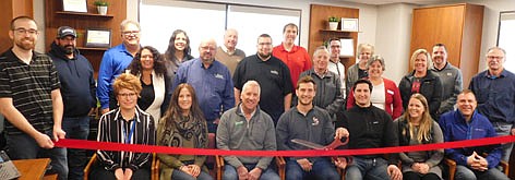 The Stewartville Area Chamber of Commerce held a ribbon-cutting ceremony last week to celebrate Jimmy's Salad Dressings & DIps' move to its new location, the former Halcon site. Jimmy's employees and leaders, seated in the front row, from left, include Kim Nosbisch, Sue Slightam, Tom Slightam, Griffin Slightam and Sam Slightam, sharing the scissors; Abby Rager and Dave Jensen. Chamber members on hand to celebrate the occasion include, standing from left in the second row, Kevin Welter of Welter Entertainment, LLC and GEOTEK, Lisa Lingle of Salt and Pepper Photography, Ty Bestor of Valor Mechanical, Josh Ihrke of Pizza Ranch, Mayor Jimmie-John King, city of Stewartville; Myrna Welter, Chamber membership coordinator; Eva Hygrell of JEH Properties, and Al Chihak of Mystic Moon Antiques and Collectibles. Back row, from left, Dave Hildebrandt of Hildebrandt Services, Greg House of House Chevrolet, Margaret Nelson of State Farm Insurance, Bill Schimmel Jr., city administrator; Dr. Kevin Hosch of 507 Family Chiropractic, Jared Johnson of HALCON, along with Ann Lutteke and Josh Buckmeier of ONB Bank.