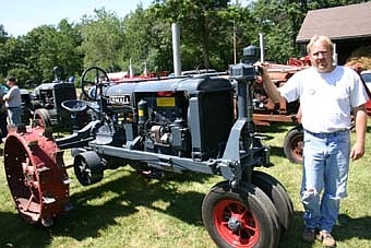 TRACTORS ON PARADE -- Trevor Wibben of High Forest enjoys tinkering with his 1936 F20 Farmall tractor. Wibben and scores of other area farmers brought their old machines to the 25th annual Root River Antique Historical Power Association Antique Engine and Tractor Show just off Highway 63 south of Racine last Friday, Saturday and Sunday. The event, which showcased International Harvester tractors, included fun activities for all ages, including a horse pull, hay bale toss contest, pinata-breaking contest and more. 