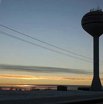 -- With the water tower near Southern Hills serving as a backdrop, the sun sets on Stewartville on Thursday, Jan. 8.                                              