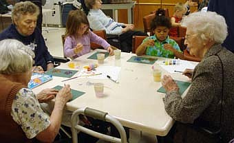 Jalynn Colligan (middle left) and Wyllow Wiley (middle right), kids from Endless Journey Child Care's preschool II class, visited the Stewartville Care Center July 22 and made suncatchers with residents (from left) Helen Scherr, Veronica Mussell and Marjorie Michaelson. 