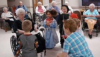 The Stewartville Care Center invited the Preschool II class from Endless Journey Child Care to a Halloween party on Oct. 29. The children mingled with the residents, played a few games and exchanged Halloween treats. Pictured above, back row from left are care center residents June Wilson, Irving Varpness, Ruth Andreasen, Helen Jameson, Lucille Voeltz and Marguerite Hudson. Front in wheelchair is Marjorie Michealson, care center resident and Endless Journey Child Care kids, Kenna Weldon (Cinderella), and Drew Anderson (Dragon Slayer). In the front with their backs to the camera are Tarin Conlin (Bumblebee transformer) from the child care center, and Ruby Bell of the care center.  