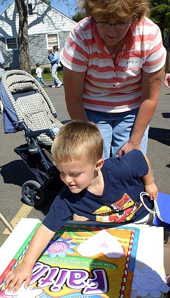 Connor Myhrvold, 3 1/2, also of Stewartville, plays the Faith match game as his mother Amy looks on at the St. John's Lutheran Church carnival on Saturday, Sept. 8. Hundreds of children and their parents attended, taking advantage of a beautiful day to enjoy games, food and more. 