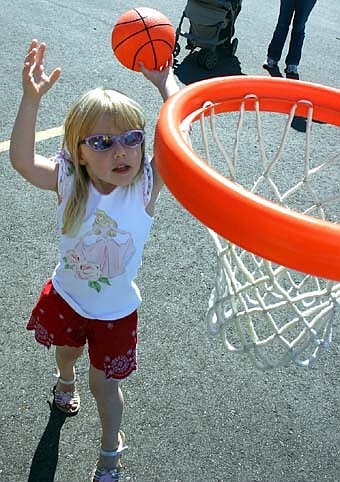 Cassidy Thompson, 3, of Stewartville, shoots the basketball at the St. John's Lutheran Church carnival on Saturday, Sept. 8. Hundreds of children and their parents attended, taking advantage of a beautiful day to enjoy games, food and more. 