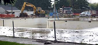 The demolition of the bath house at the old pool began on Sept. 18, as construction of the new aquatic center continues just south of the demolition site. 