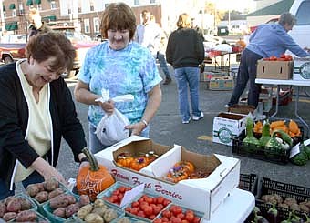 Scores of customers shop for good deals at the Farmer's Market at the ACE Hardware parking lot each Friday from 3-7 p.m. 