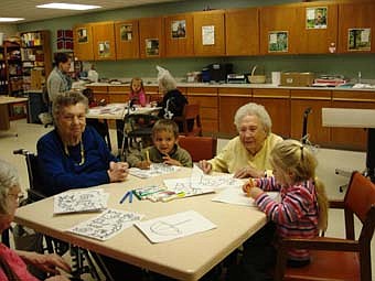 Some children from the preschool 1 class at Endless journey Child Care visited the Stewartville Care Center April 28. They colored with the residents and brought a treat to share - frosted sugar cookies! Pictured from left are Veronica Mussell, Stewartville Care Center resident, Andrew Payton, from the child care center, Marguerite Hudson, resident at the Stewartville Care Center, and Holly Sexton, of the child care center. 