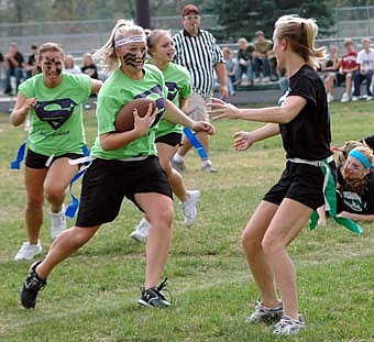 senior ball carrier Cait Donahoe, cuts to the inside during the homecoming Powder Puff football game on Monday afternoon, Sept. 24. The seniors defeated the juniors, 6-0. 