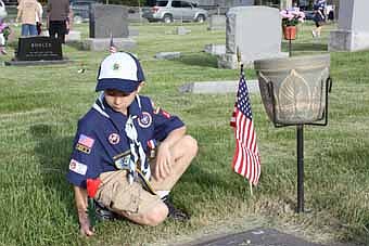 The evening of Friday, May 28, Stewartville Cub Scouts, along with representatives of the American Legion, were out in force placing poppies on the graves of veterans buried in Woodlawn Cemetery. Flags were already positioned on the gravesites. The boys walked in a row and placed the poppies on the graves to the right of the flags. This was a good time to impress upon the boys the need to show respect for our fallen heroes and for the cemetery in general. It is their civic duty to help and they enjoy getting the cemetery ready for Memorial Day. 