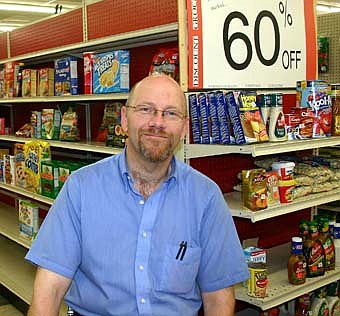 PLENTY OF GROCERIES -- Marty Hanson, co-owner of Hanson's Country Store,  offers a large inventory of discount groceries which have been selling well recently.  "The groceries are coming off the shelves faster than we can fill the shelves," he said. 